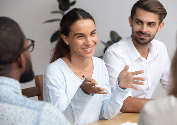 A diverse group of teachers collaborate in a meeting