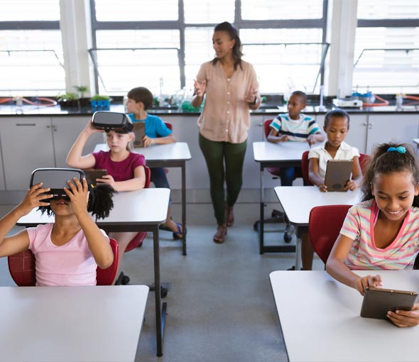 A special education teacher walks amongst her students