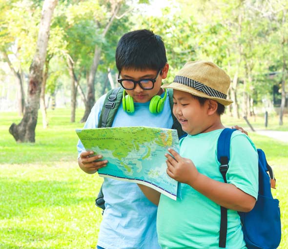 Two elementary special education boys look at a map during a school field trip